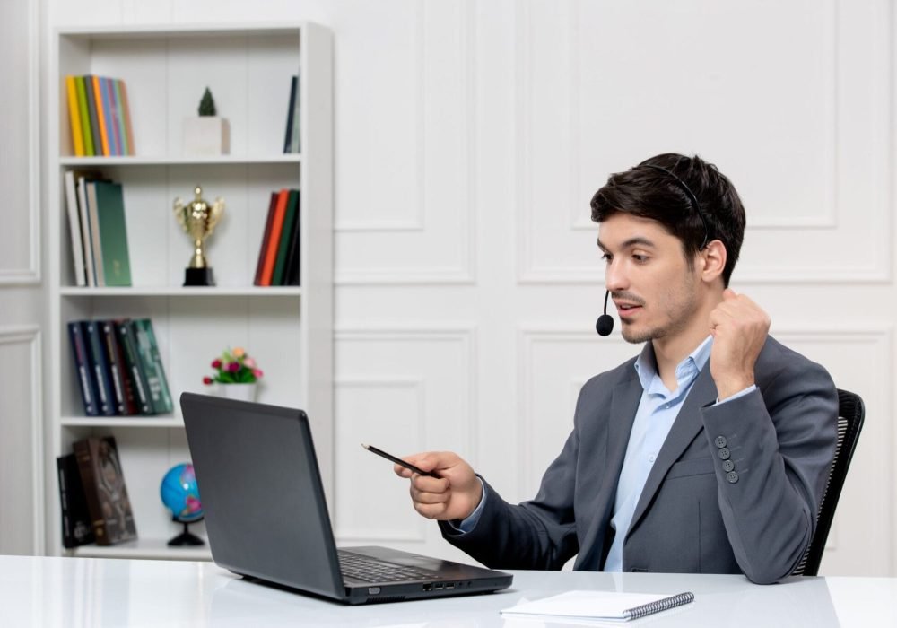 customer-service-cute-guy-grey-suit-with-computer-headset-holding-fists-up
