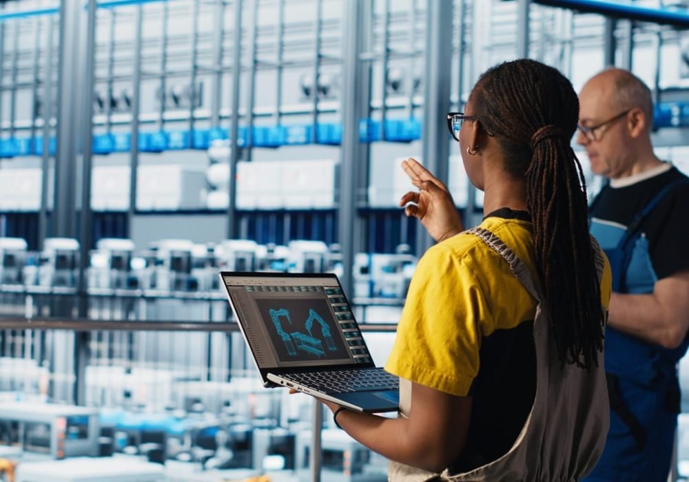 Engineering team working in smart factory, collecting and analyzing data. Teamworking colleagues using tracking software in industry 4.0 industrial plant equipped with advanced sensors, camera A